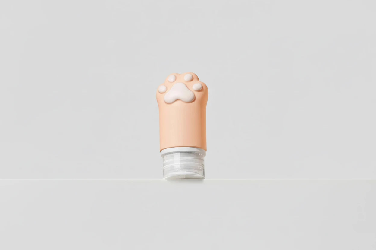 Cosmetic tube with a paw print design on a light gray background
